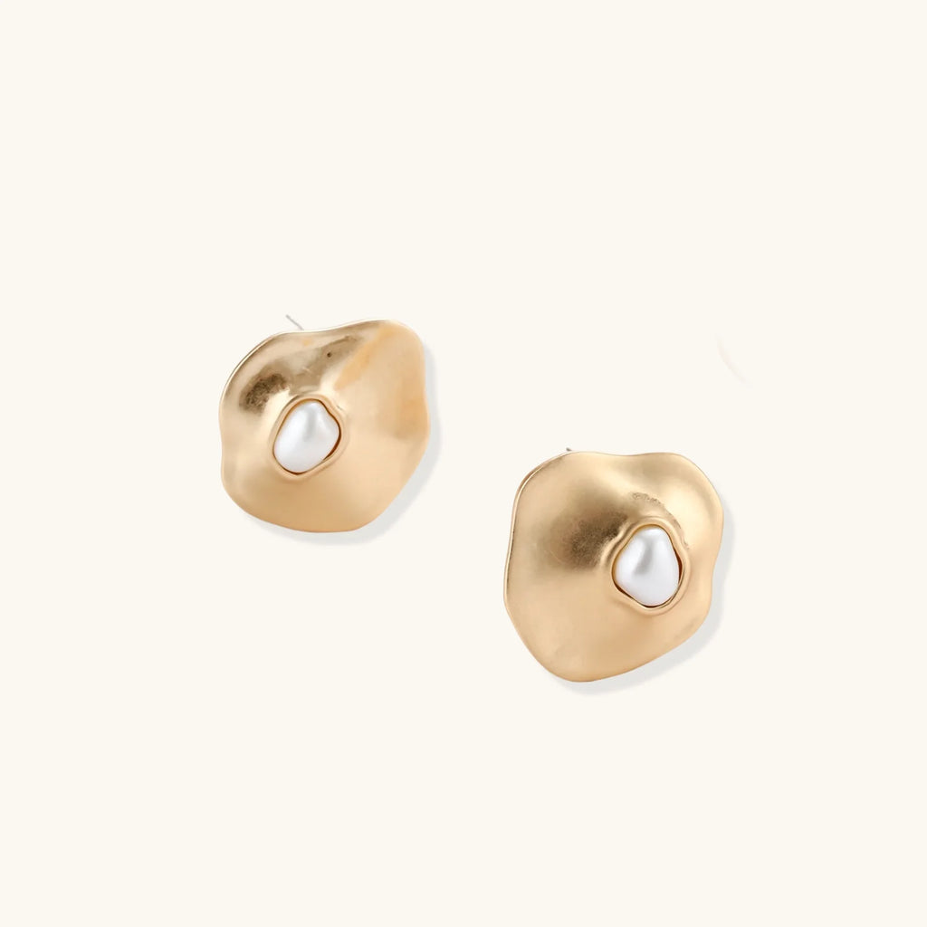 Organic-shaped eco-zinc alloy stud earrings with resin pearl centers and sterling silver posts on white background.