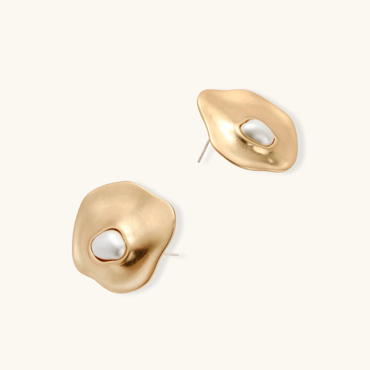 Organic-shaped eco-zinc alloy stud earrings with resin pearl centers and sterling silver posts on white background.