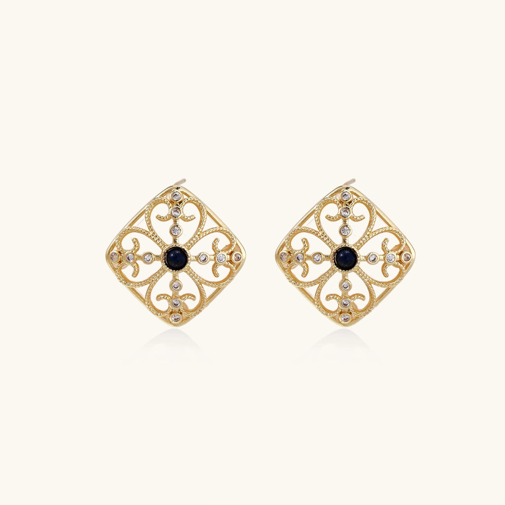 Gold filigree stud earrings with navy lapis lazuli center stone and mother-of-pearl accents in ornate quatrefoil design