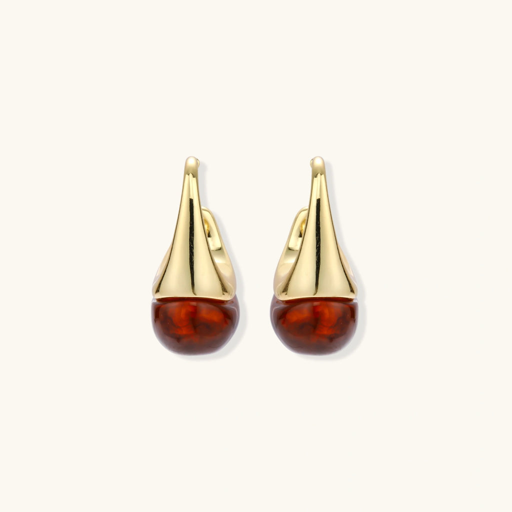 Modern drop earrings with curved gold-plated copper tops and amber resin bottoms creating an organic teardrop silhouette.