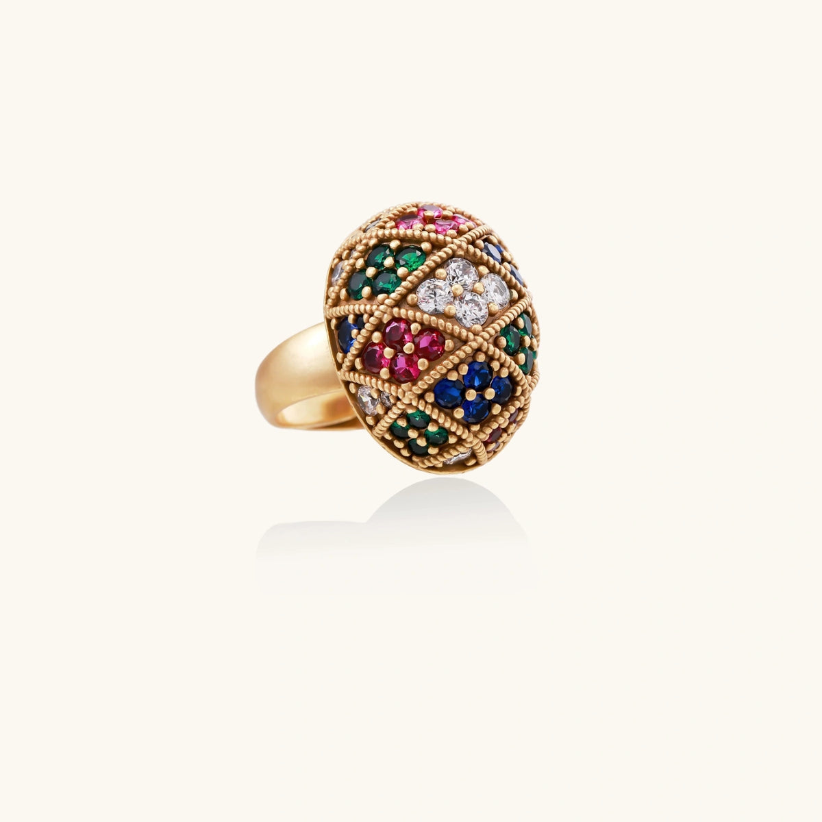Oversized gold ring with geometric mosaic pattern featuring multicolor zirconia stones in ruby, emerald, sapphire, and clear tones.