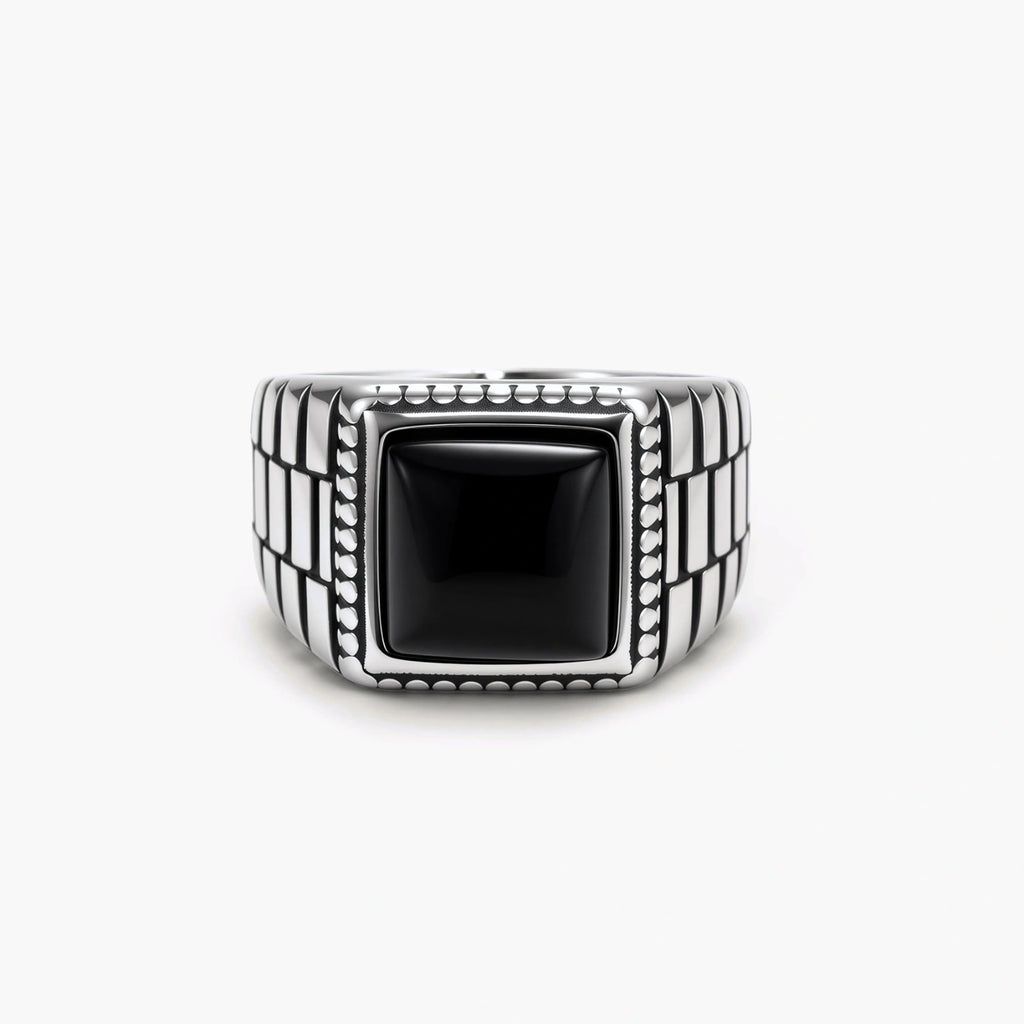 Silver stainless steel signet ring with checkered band texture, beaded border, and square black onyx cabochon stone center.