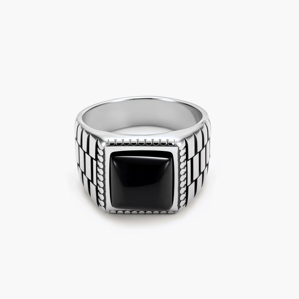 Silver stainless steel signet ring with checkered band texture, beaded border, and square black onyx cabochon stone center.